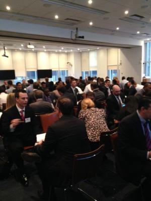 Crowded room of people sitting together talking