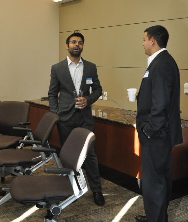 two men standing and talking