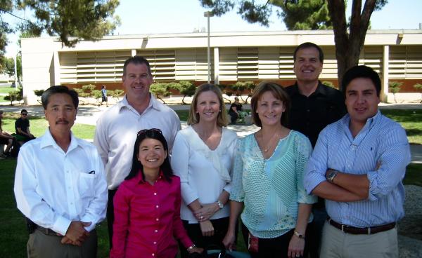 people pose for group photo outside