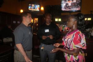 two men and a woman standing and talking toghether